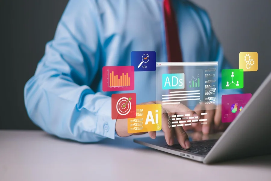 A person typing on a laptop with hovering advertising graphics and metrics overlay.
